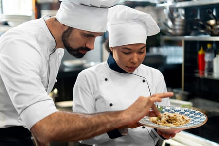 experienced staff teaching there juniors in restaurant